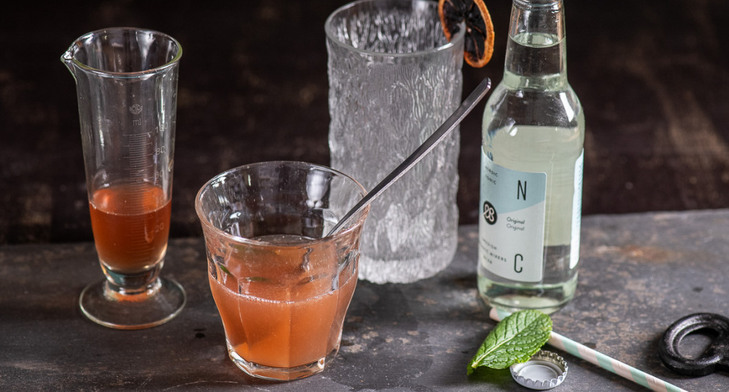 Blanda honungssirap, tranbärsjuice och pressad lime i ett glas. 