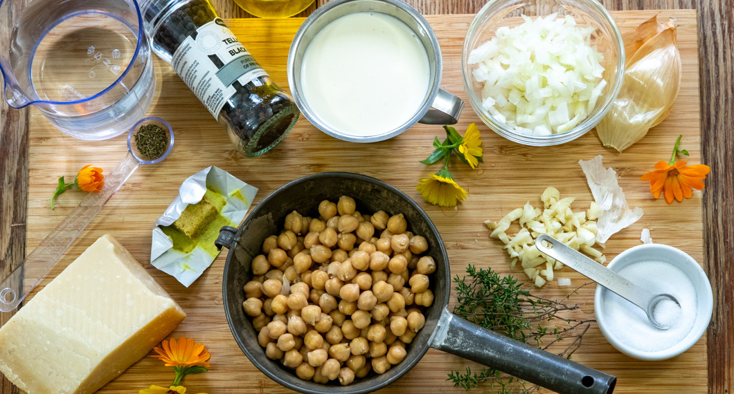 Ingredienser till soppan med kikärter, vitlök, lök, grönsaksbuljong, vatten, grädde, salt och timjan samt parmesan 