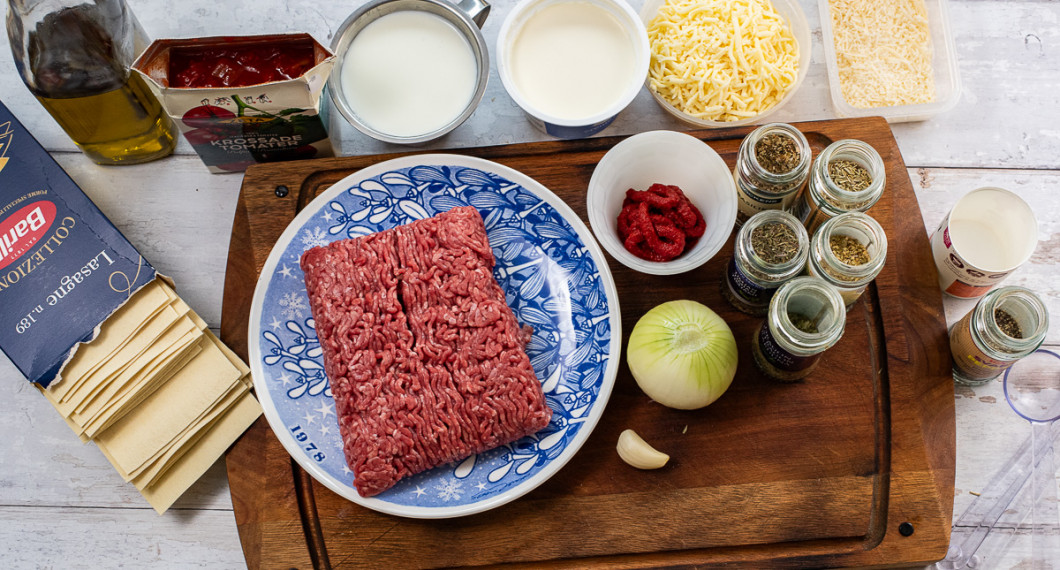 Till lasagnen behöver du lasagneplattor, olivolja, krossade tomater, mjölk, crème fraiche, köttfärs, vitlök, lök, tomatpuré, riven ost, parmesan, basilika, oregano, timjan, rosmarin, dragon, svartpeppar och salt.