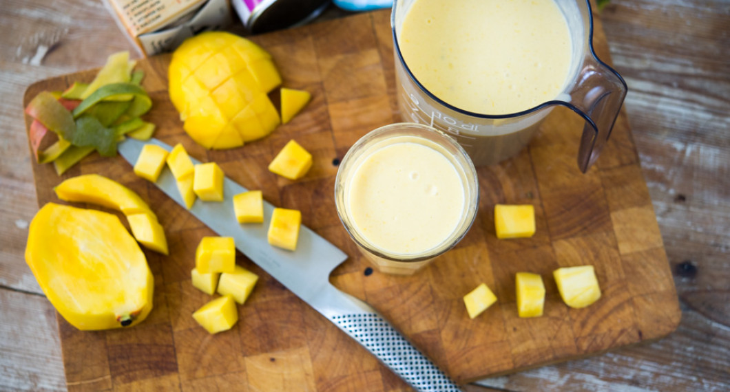 Mangosmoothie med kokosmjölk och havremjölk i glas. 