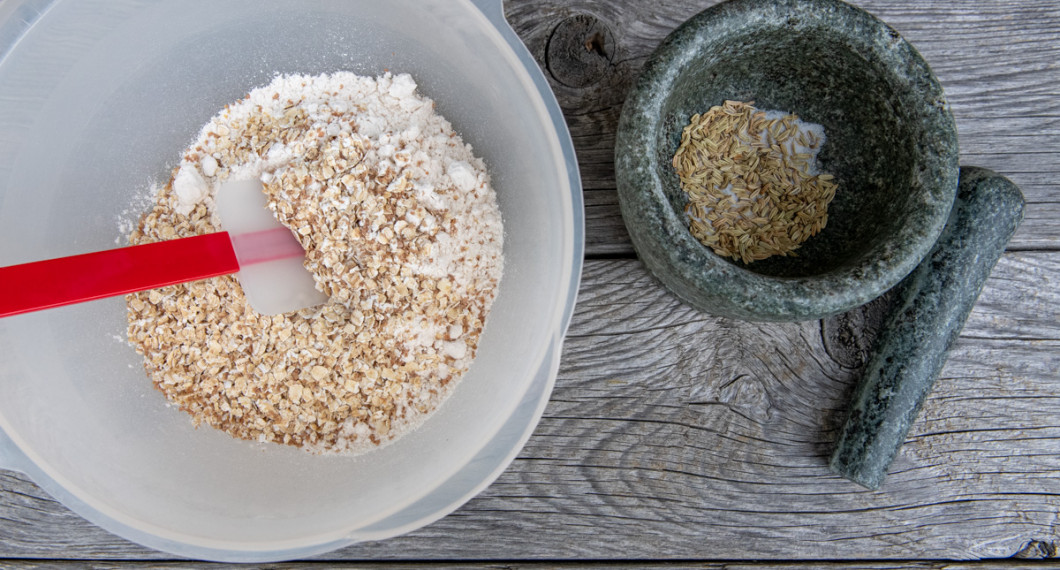 Dinkelmjöl, havregryn, salt, solrosfrön, bakpulver eller bikarbonat blandas i en bakbunke. Mortla fänkålsfröna. 