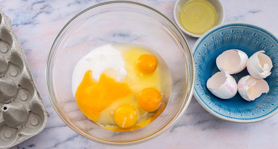 Mät upp socker samt 3 ägg och 1 äggula i en stor bunke. 