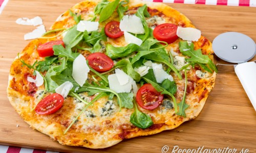 Pizza med gorgonzola på skärbräda