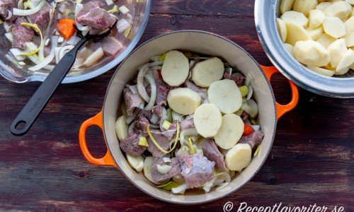 Köttet varvas med potatis i grytan