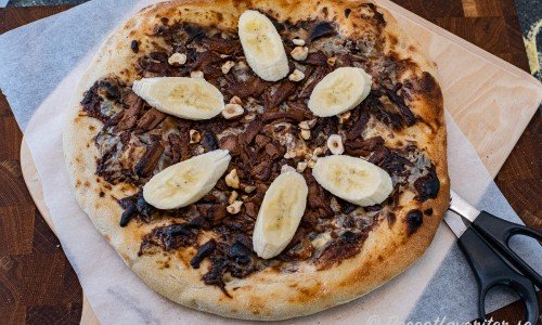 Chokladpizza - en dessertpizza med crème fraiche, nutella och mjölkchoklad toppad med rostade hasselnötter och banan. 