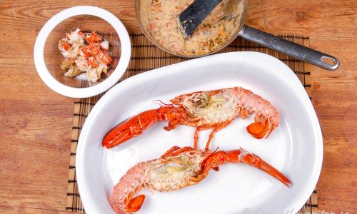 Urtagna kokta humrar med hummerkött och sås till stuvningen vid sidan