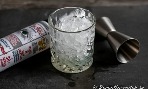 Blanda absinthe med krossad is i glaset drinken ska serveras i. 