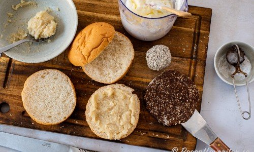 Fyll först semlorna med mandelfyllning. Platta till och forma en chokladboll så den liknar en rund burgare. 