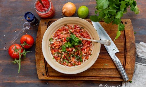 Ingredienser till tomatsalsan: färska tomater, chili som chiliflakes, krossade tomater, gul lök, lime och färsk koriander. 