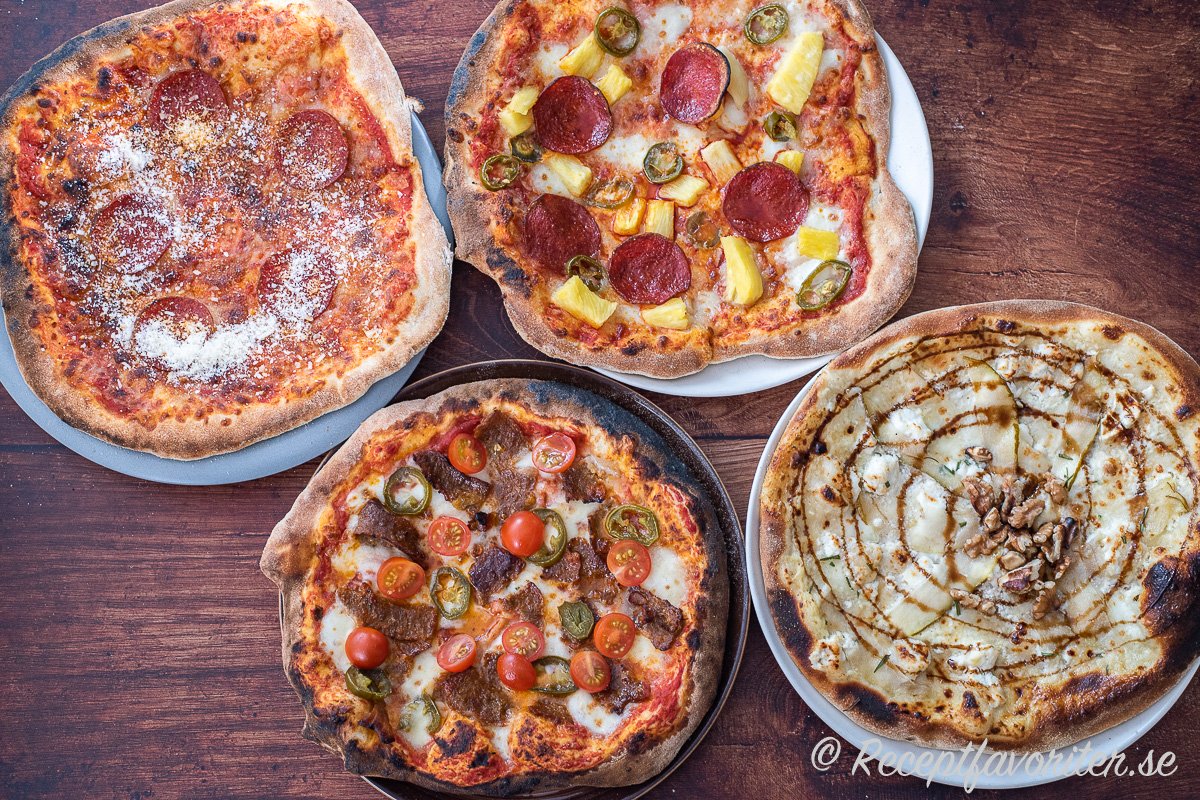 Lite olika pizzor bakade i pizzaugn för hemmabruk. Pepperonipizza, kebabpizza, pizza med ananas, pepperoni och jalapeno samt en vit Bianco med chèvre, päron och honung. 