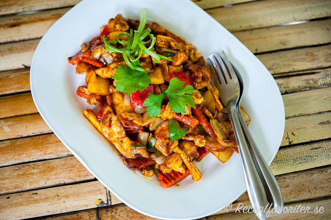 Thaikyckling wok med cashewnötter och grönsaker på fat Thaikyckling wok med cashewnötter och grönsaker på fat