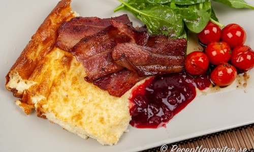 Äggakaka skånsk pannkaka med fläsk och lingon serverad med en sallad. 